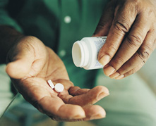 Male with Pills in His Hand